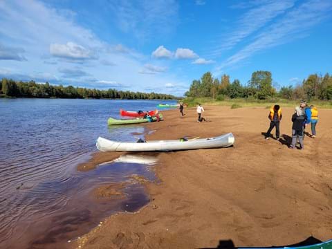 Kanoter på en strand och elever från Strandskolan i Överkalix